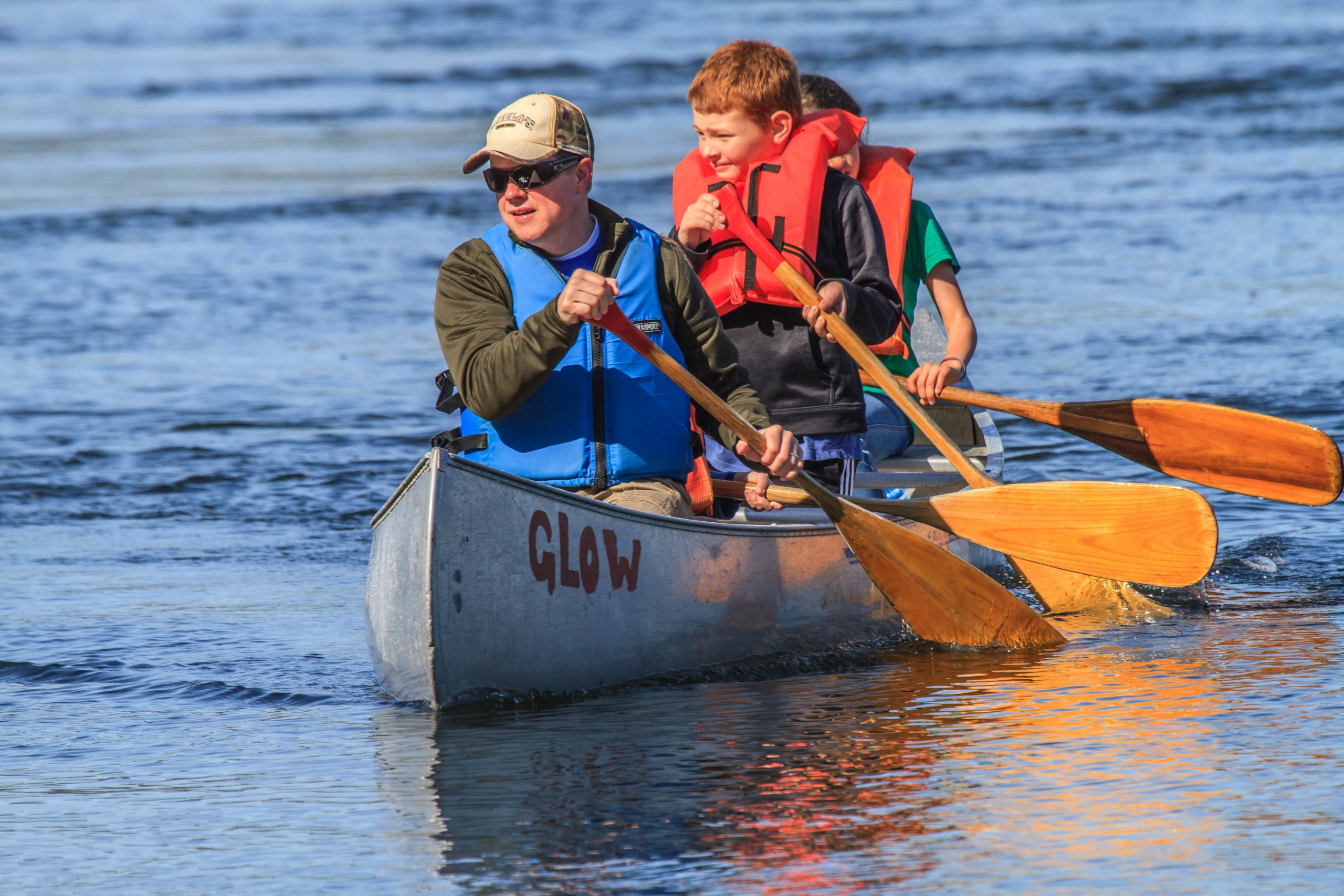 Adults and kids canoeing on the Puget Sound