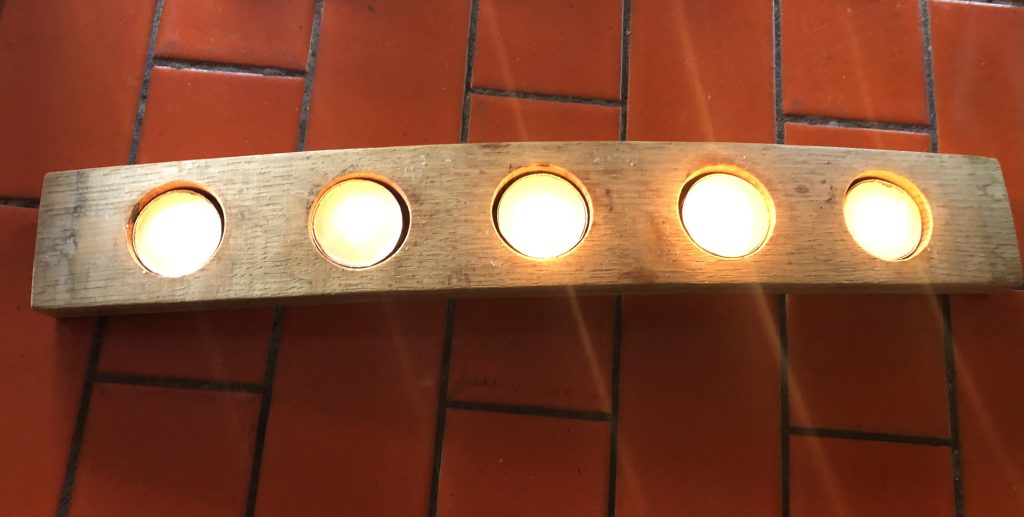 5 tea light candles in a candle holder made from a barrel stave