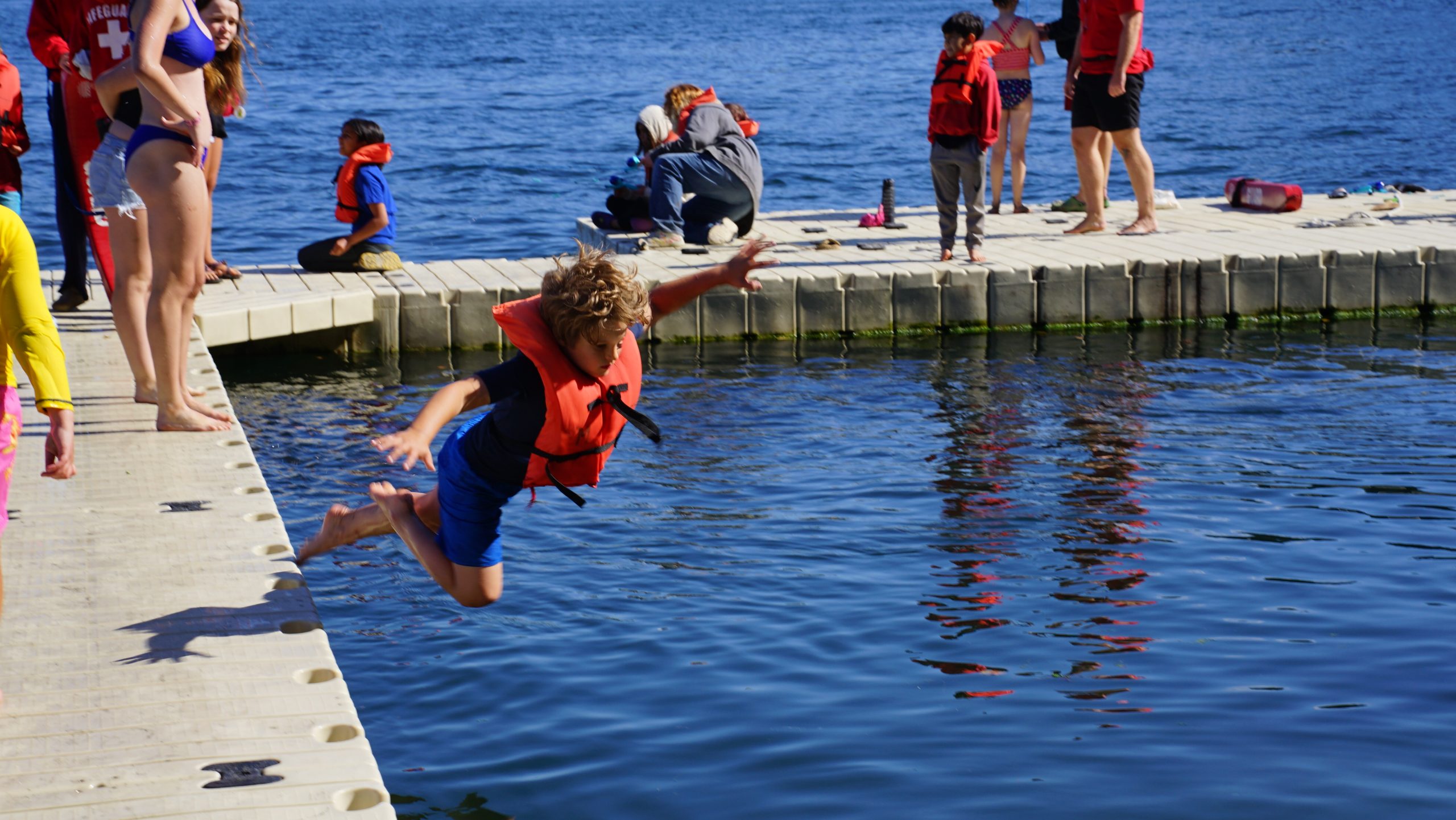 camper diving into the water off the dock