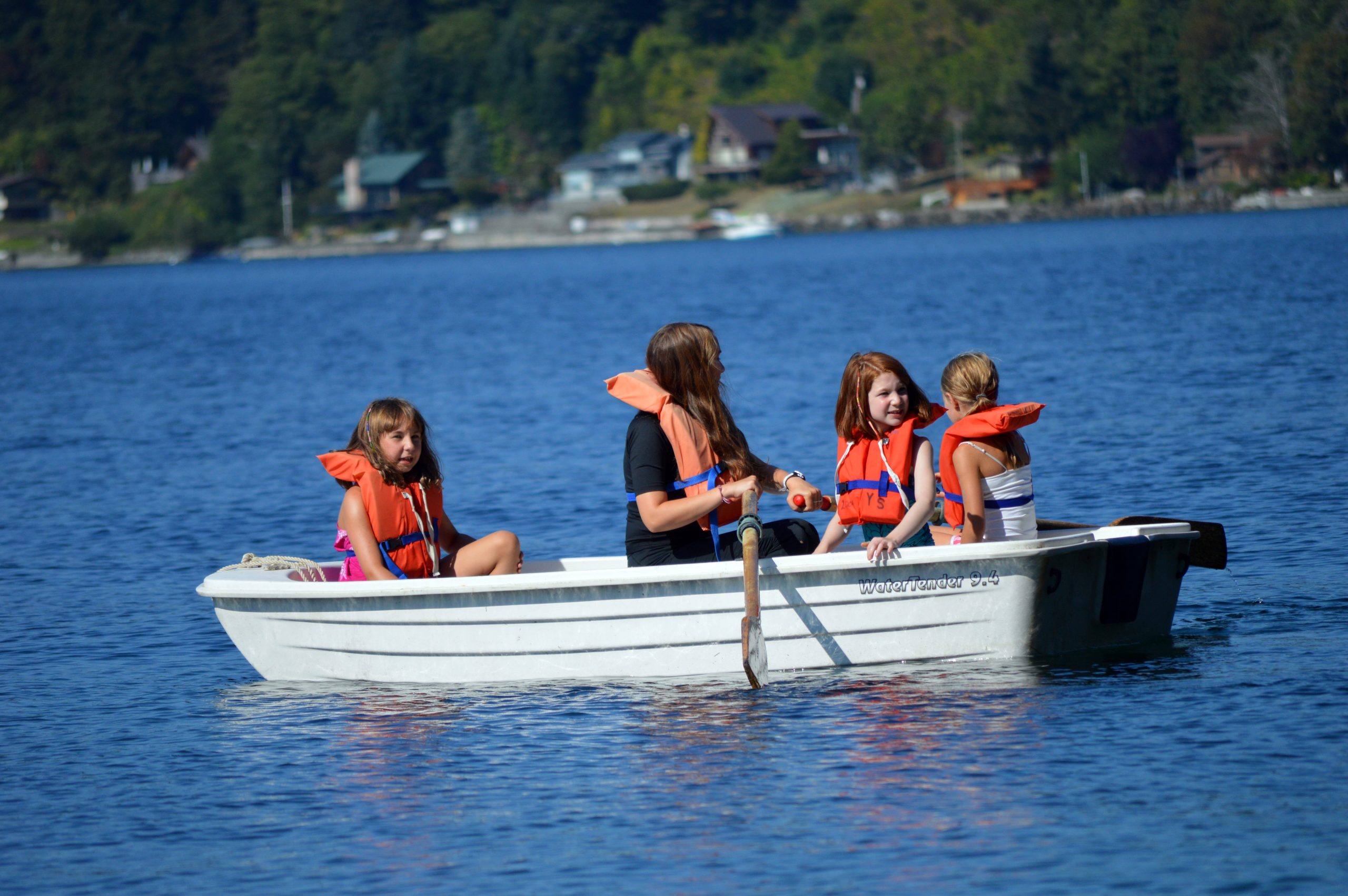 Campers and counselor in row boat