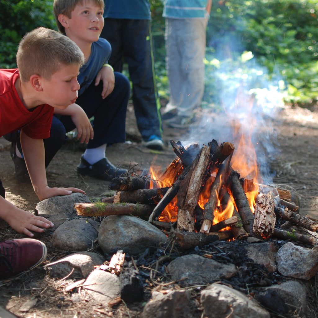 Camper building campfire