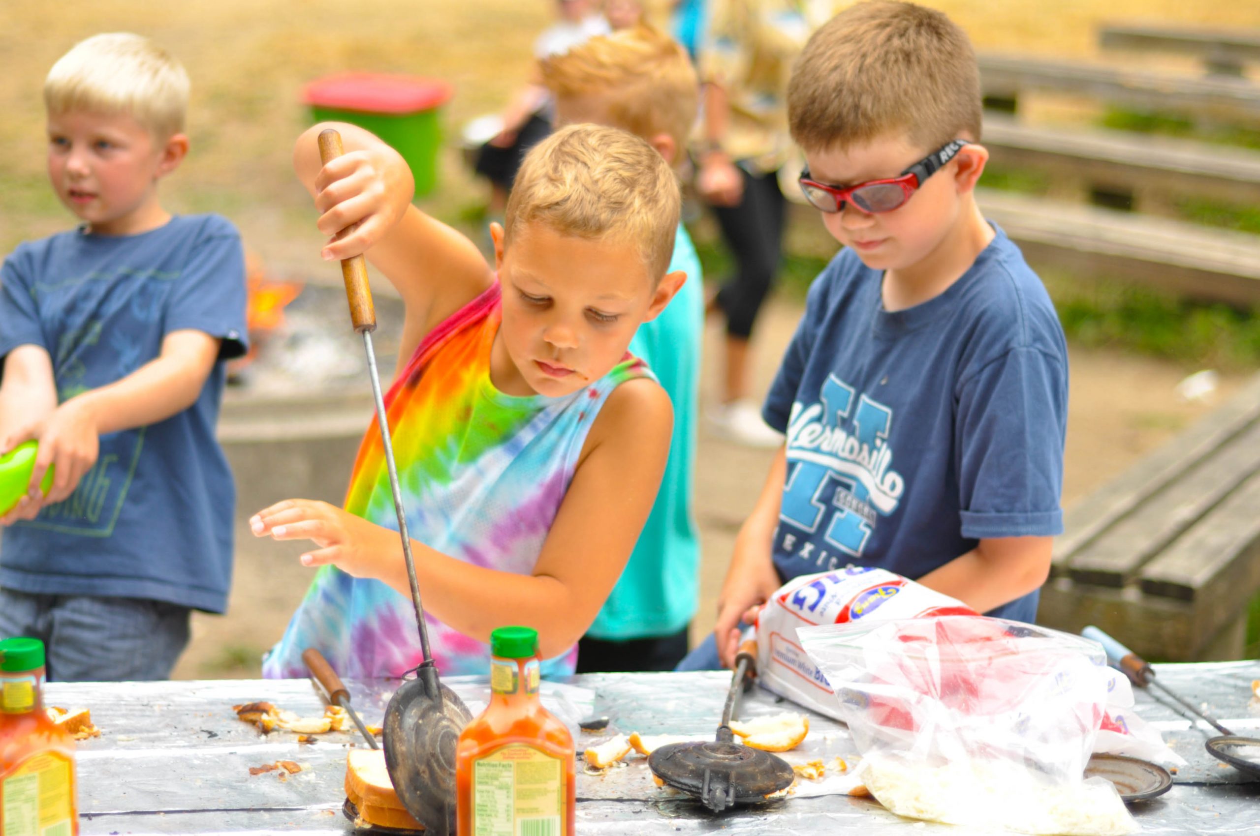 Campers cooking with pie irons at Day Camp