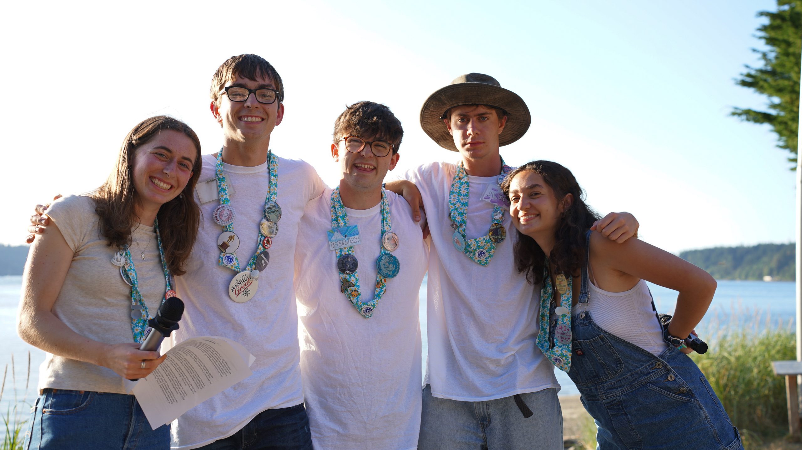 a group of staff pose for a group picture in their blues and whites during closing camp fire