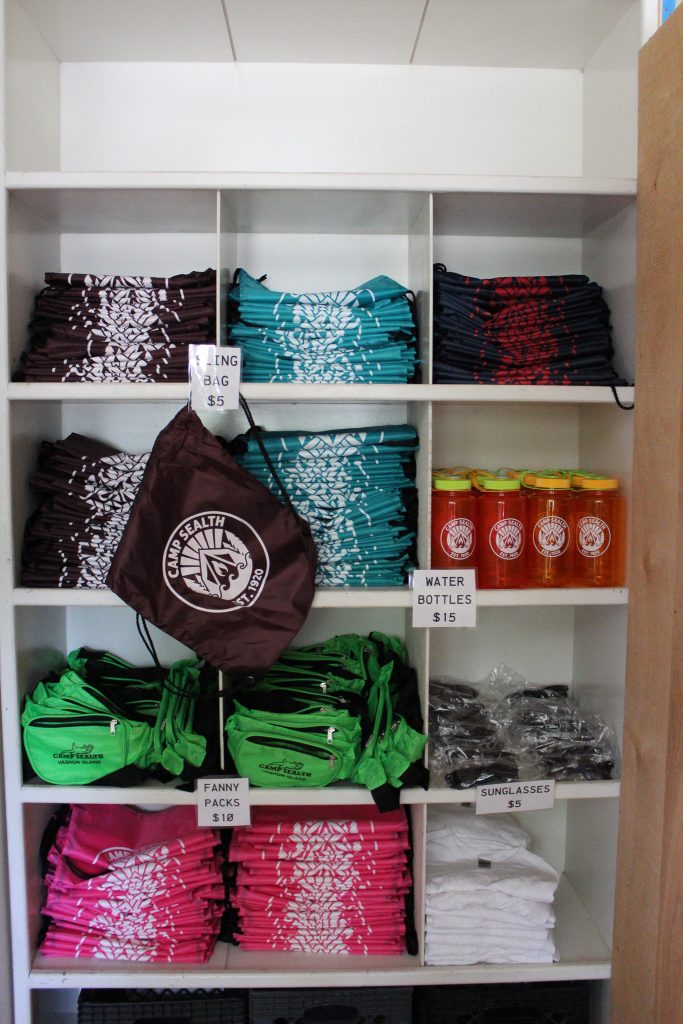 Cubbies holding folded shirts, water bottles, and drawstring backbacks