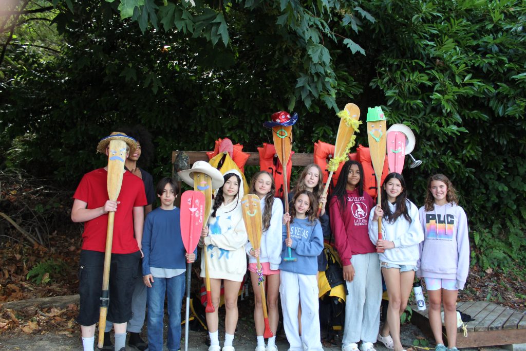 group of campers and staff with canoe paddles