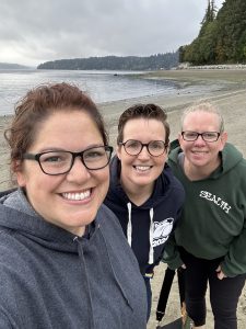 3 adult hikers on the beach