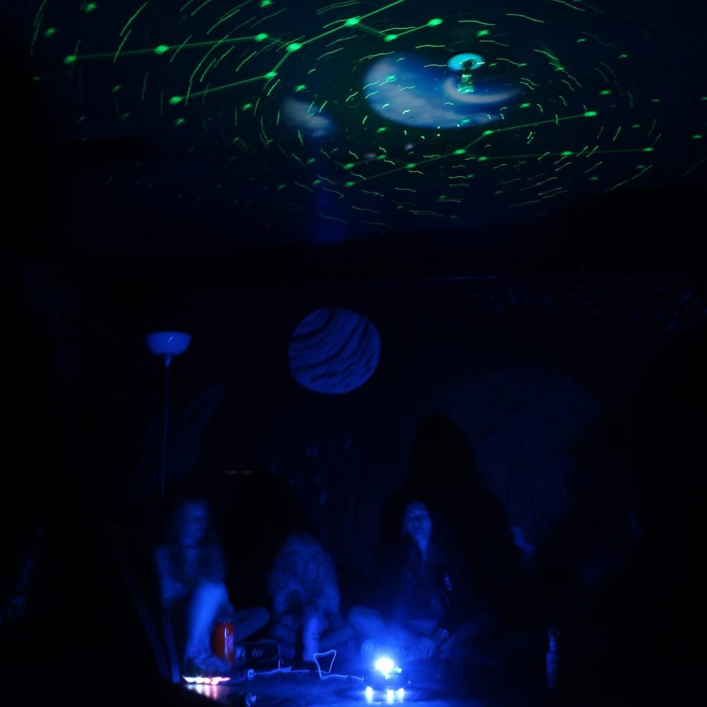 Stars are illuminated on the ceiling of a dark room