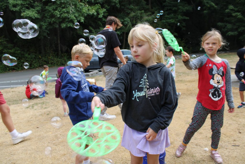 Camper blowing bubbles at Day Camp