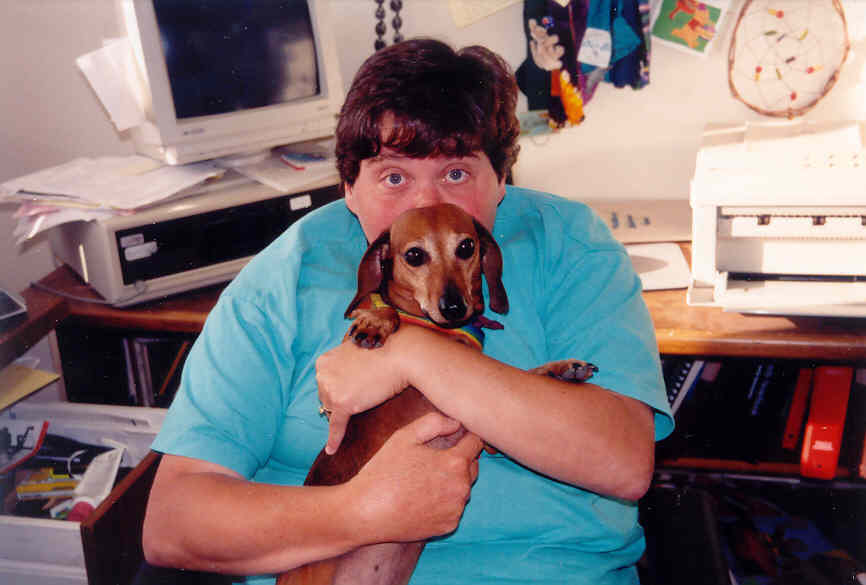 a woman holding a small dog