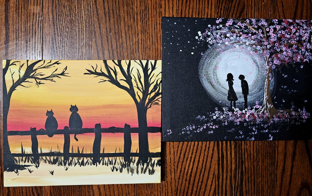 Two paintings on canvases. One is of a sunset behind trees and fence silhouette and the other is a moon behind the silhouettes of two people 