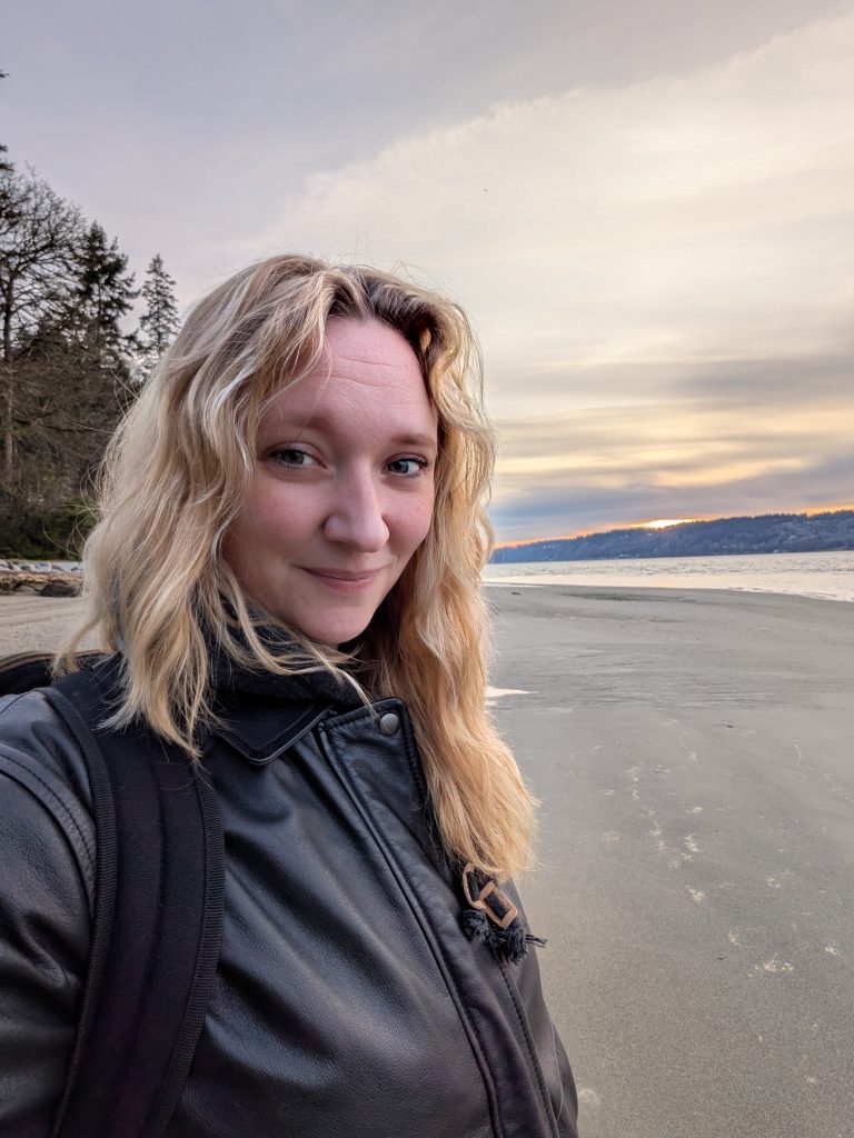 a woman's selfie taken in front of the ocean