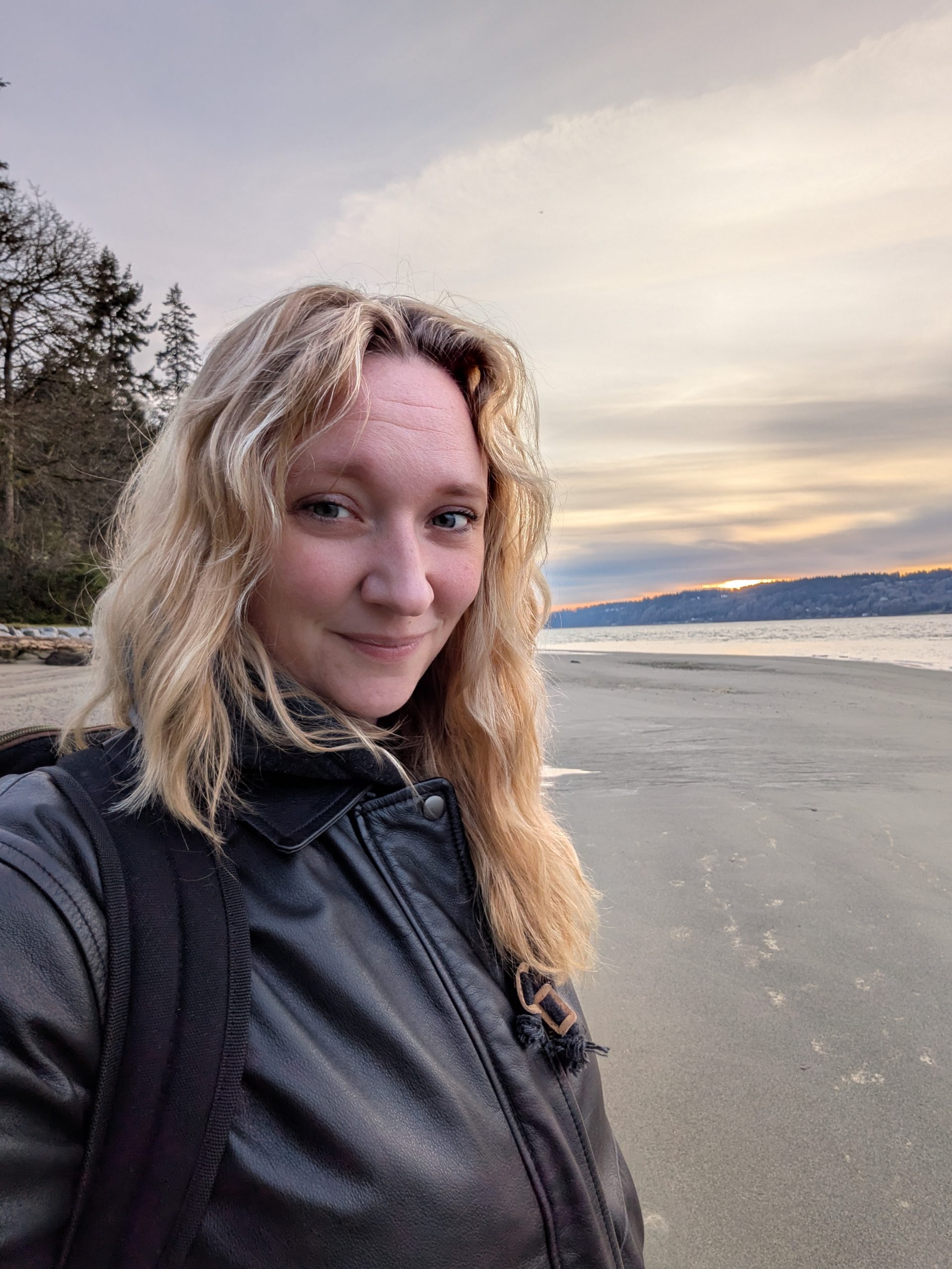 a woman's selfie taken in front of the ocean